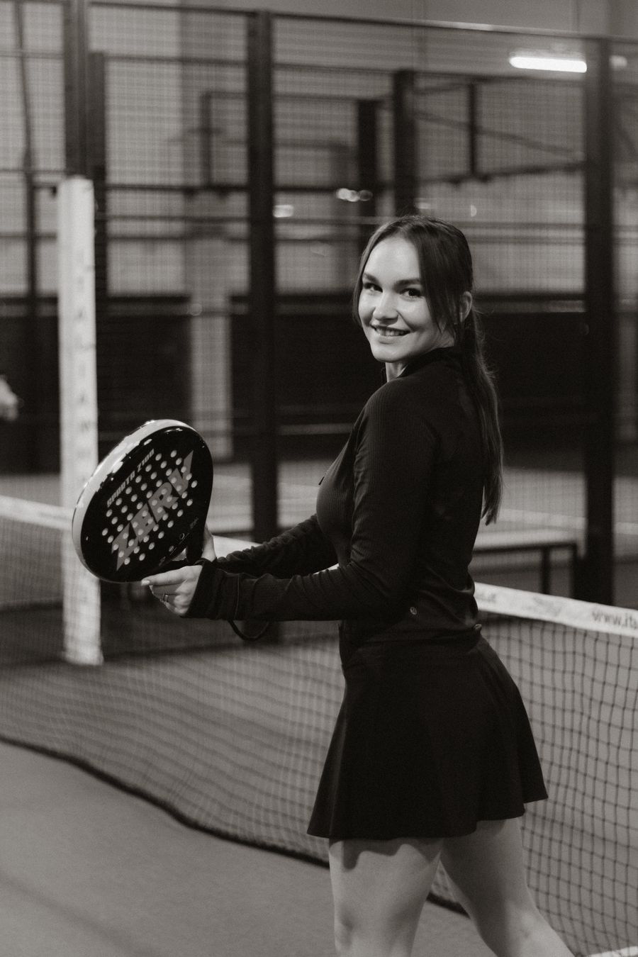 Padel player laughing with a racket in hand