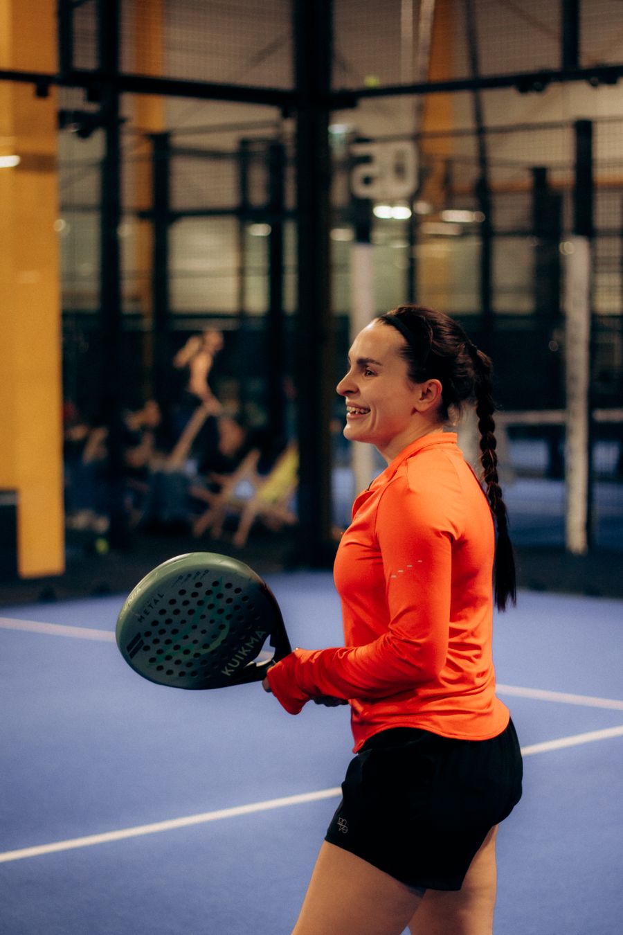 A welcoming padel player ready to play at a social event